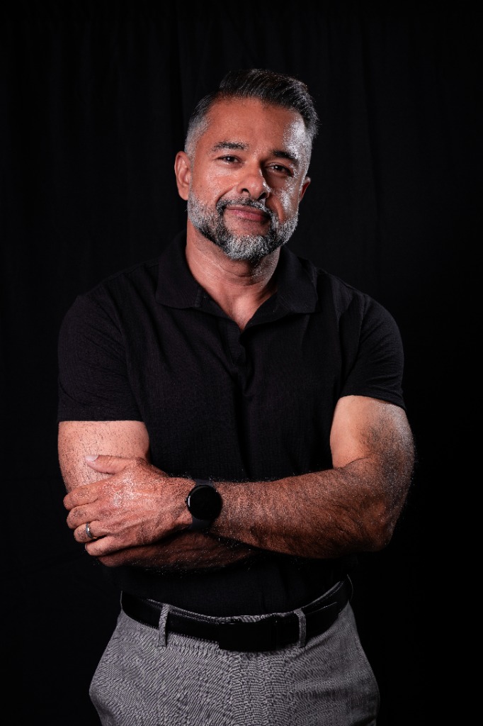 Lifestyle - Black polo arms crossed portrait