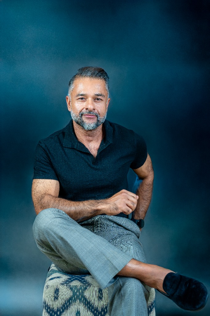 Lifestyle - Seated moody blue backdrop
